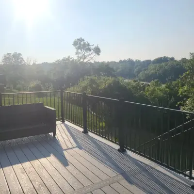 36x24 Massive composite deck featuring black aluminum railings and dual entry steps by Jaguar Decks And Fences