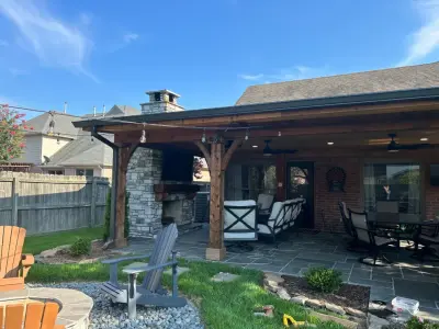 Collierville outdoor living space expansion featuring a wood-burning fireplace and complete kitchen — Deck Building & Repair project by Accurate General Construction