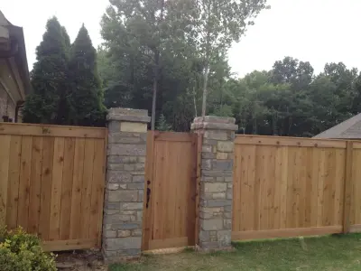 Cedar fence with stone pillars and sheared edges — Deck Building & Repair project by Accurate General Construction