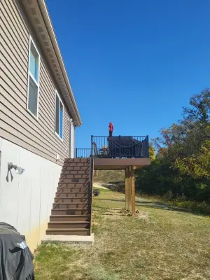 14x16 Brown Composite Bungalow Deck with Coordinating Fascia and Black Aluminum Railing — Deck Building & Repair project by Jaguar Decks And Fences