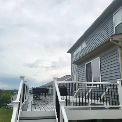 32x16 Clamshell Composite Trex Deck with White PVC and Black Aluminum Spindles — Deck Building & Repair project by Jaguar Decks And Fences