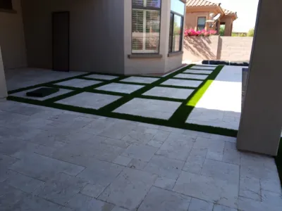 Travertine and artificial turf. — Landscape Construction project by Saguaro Landscaping And Pool Service LLC. in Scottsdale