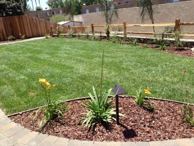 Country manor firepit, seatwalls, terraced retaining walls, and paver patio — Landscape Construction project by San Diego Landscape Solutions Inc