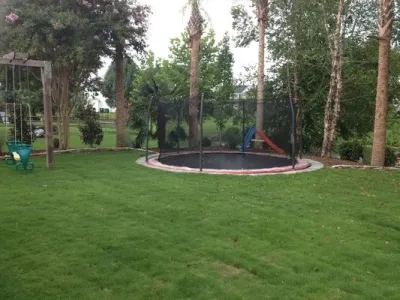Charlotte NC - Trampoline landscaped back yard — Landscape Construction project by SecureTurf - Charlotte Landscaping Experts