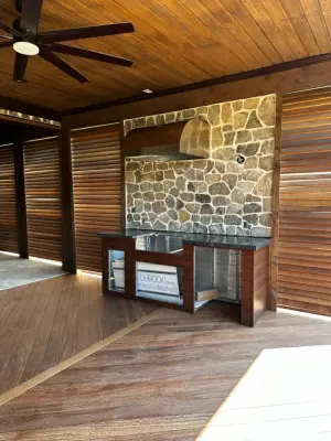 Transformed Deck into a Stylish Outdoor Living Area with Kitchen, Vent Hoods, and Fireplace — Deck Building & Repair project by Atlanta Porch & Patio