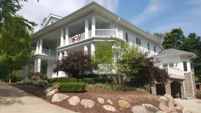 Home with Covered Porch and Water Management System for Dry Space Below — Deck Building & Repair project by Miles Bradley Building And Remodeling