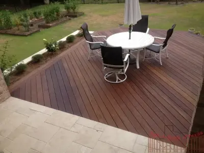 Ipe Wood Deck with Metal Support and Limestone Planters Surrounding Deck — Deck Building & Repair project by Austin Add-A-Deck