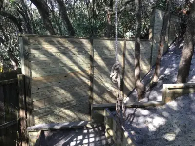 Aluminum-framed lattice gate adjacent to a lateral fence supported by 4x6 posts — Deck Building & Repair project by Garden Home Spaces