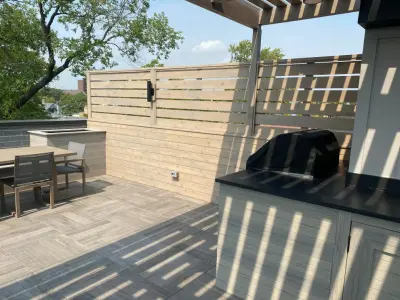 Lincoln Park Rooftop Deck Featuring Pergola, Buffet Area, Spa, Turf, and Privacy Walls — Deck Building & Repair project by Unique Deck Builders
