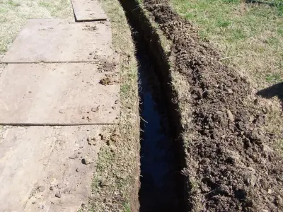 French Drain Systems — Driveway Repair & Paving project by Tulsa Quality Foundation Repair And Drainage