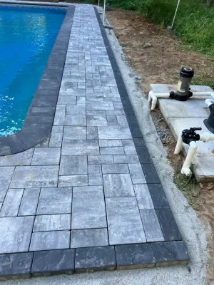 Paver installation around the swimming pool — Stone & Concrete Installation project by Five Star Contractors