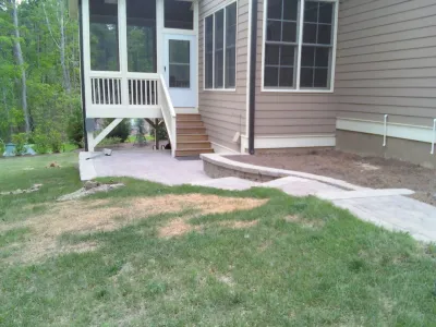 Custom Patio with Sitting Wall and Firepit by Sutton Outdoor, LLC