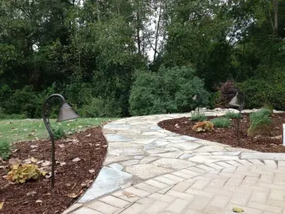 Expanded patio with stone wall — Stone & Concrete Installation project by Twin Oaks Landscape, Inc.