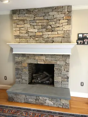 Bespoke Stone Fireplace with Mantel by Hefel Masonry LLC