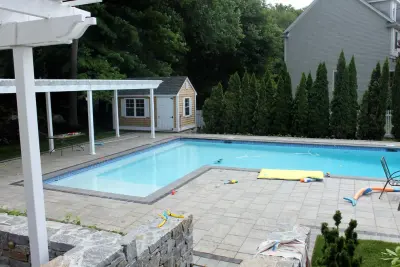 Andover, MA Paver Pool Deck and Natural Stone Walls — Stone & Concrete Installation project by Premier Pavers & Hardscape Co