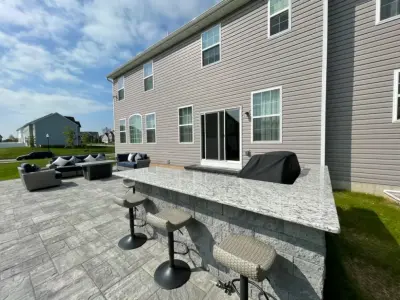 Cambridge Limestone Quarry Blend Outdoor Patio and BBQ Area by Hardscape Artists LLC
