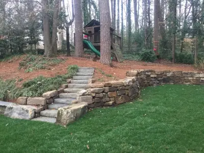 Chastain Park children's play space in the backyard — Stone & Concrete Installation project by PaverStone Construction And Greenmark Landscaping