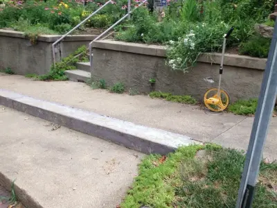 Stone Retaining Wall with Cobblestones — Stone & Concrete Installation project by Markuson Mark III Construction