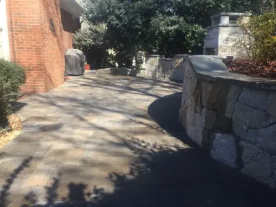 Dunwoody compact outdoor space featuring a fireplace — Stone & Concrete Installation project by PaverStone Construction And Greenmark Landscaping