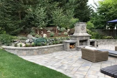 Aguiar Pavers' Patio with Fireplace and Seating Wall — Stone & Concrete Installation project by Aguiar Pavers LLC