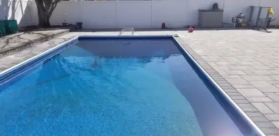 Islip patio for the pool — Stone & Concrete Installation project by Legacy Brick & Stone
