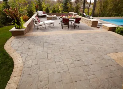 Creating a Splash: Tiered Paver Pool Deck with Retaining Wall — Stone & Concrete Installation project by Anchor Block Company