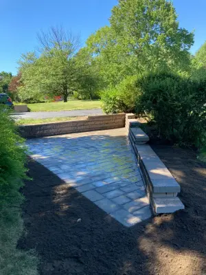 Retaining wall paver patio — Stone & Concrete Installation project by Legacy Masonry & Hardscaping
