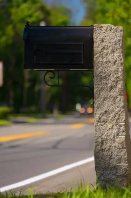 Reclaimed granite mail post — Landscape Construction project by Village Stonesmith Gardens & Masonry in Concord