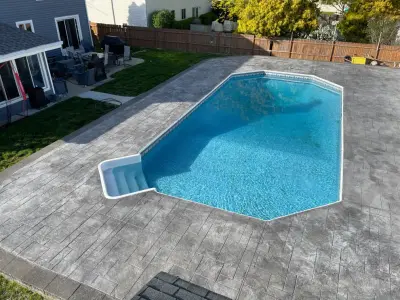 Sewell imprinted concrete swimming pool terrace — Stone & Concrete Installation project by Metric Concrete Construction & Design Inc.