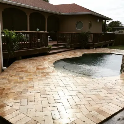Seminole Travertine Pool Deck — Stone & Concrete Installation project by JR Pavers Inc.