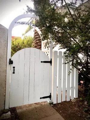 Tudor-style fence, arbor, and gate — Stone & Concrete Installation project by Swan General Homestead