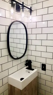 Monochrome Matte Black Subway Tile Bathroom — Flooring Installation Services project by TC Wilka Artisan Floors LLC