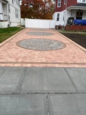 Nicolock Paver Driveway with Circles and Dark Brown Inlay — Landscape Construction project by Joseph Matthew Landscape Inc Design & Build in Massapequa