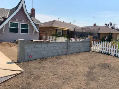 Front Yard Transformation (Cobblestone Fence, Grass, Idaho Quartzite Slabs) by San Jose Tree Service & Landscaping