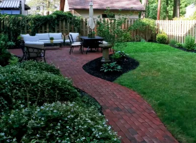 Croydon back yard patio area — Landscape Design project by Aureli Landscaping & Custom Stone Work in Rochester