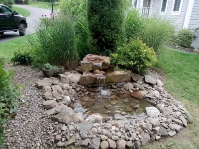 Waterfalls with pond — Landscape Design project by Aureli Landscaping & Custom Stone Work