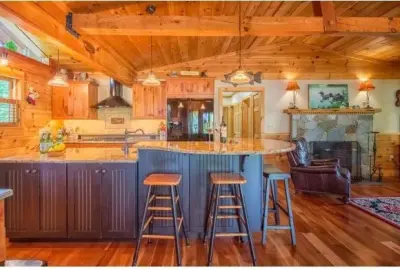Country-Style Log Cabin Kitchen by The Cabinetworks