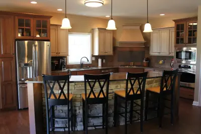 Elegant Stone Island Kitchen by Kitchens & Interiors, Inc.