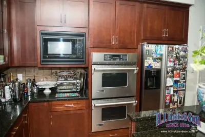 Transformed White High Gloss Kitchen Cabinets - Before and After by H.J. Holtz And Son, Inc.