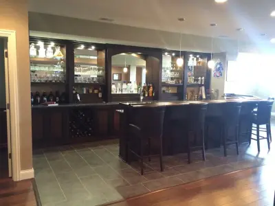 Upper Level Master Suite with Basement Bar by Bucher Construction