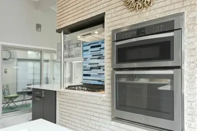 Forest Oaks Midcentury Modern Kitchen by Virtuoso Builders