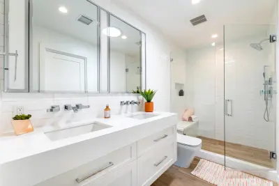 Sleek White Bathrooms by JRP Design & Remodel