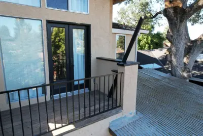 Contemporary Black Metal Deck Fence – Stylish Outdoor Enhancement by Noor Construction Inc.