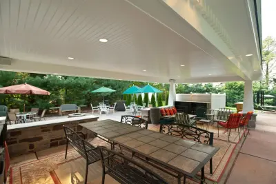 Outdoor Living Areas: Sheltered Patio and Swimming Pool by Penn Contractors Inc