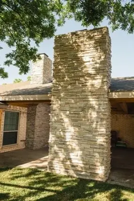 Exterior Stone Fireplace with Cedar Roof and Ceiling — Home Renovation & Remodeling Services project by ABC Contractors