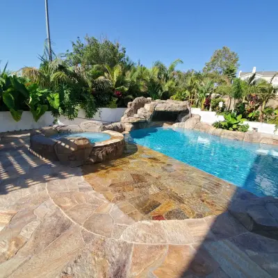 Flagstone Patio with Custom BBQ and Fire Pit for Pool Landscaping — Home Renovation & Remodeling Services project by EMC General Contractors