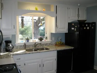 Transforming Wooden Cabinets to White — House Painting Services project by S & S Painting