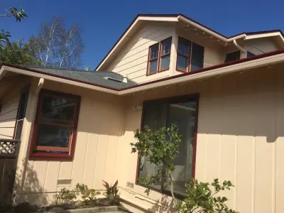 Pink Exterior with Red Trim of Circles Neighborhood — House Painting Services project by Transformational Color