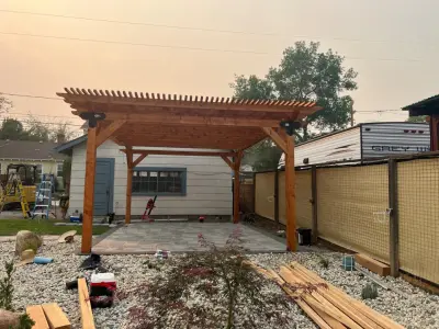 Patio pavers with a redwood pergola — Landscape Construction project by Jefe's Landscaping
