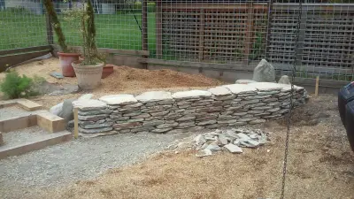 Stacked stone wall — Landscape Construction project by Fire Sparrow Landscaping